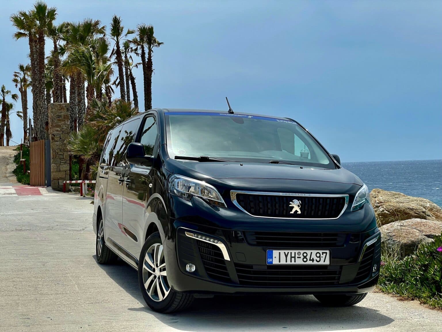 Front view of the Island Chauffeur Peugeot Traveller beside the sea